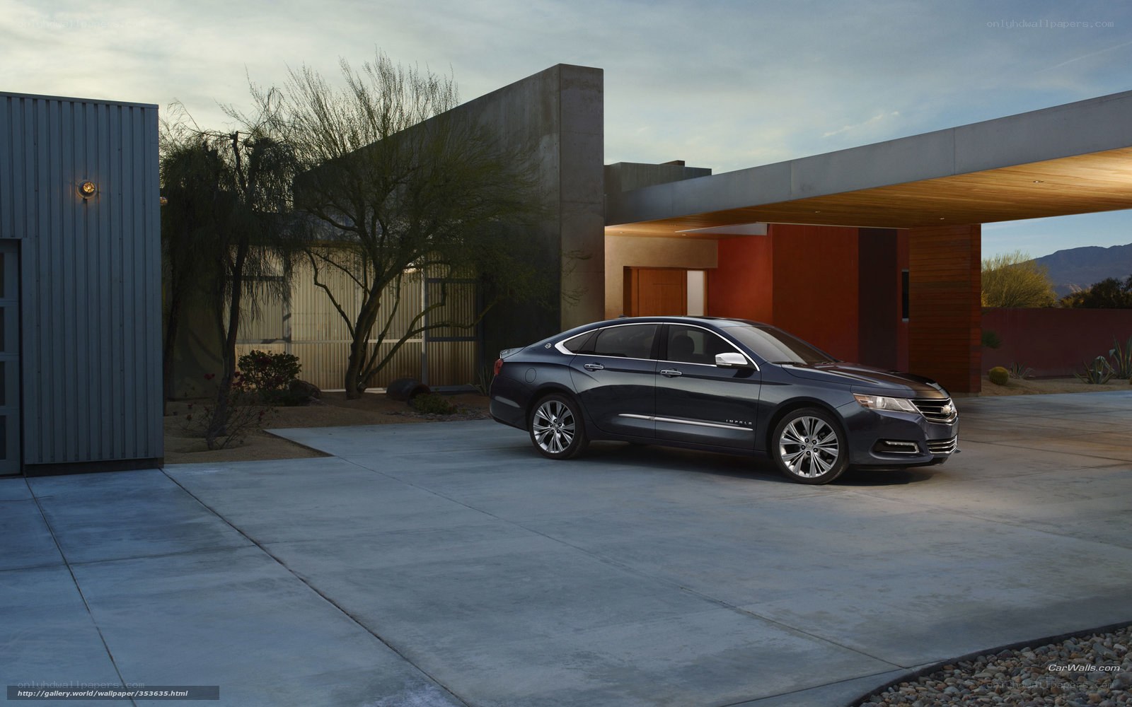 Dark sedan parked in modern driveway