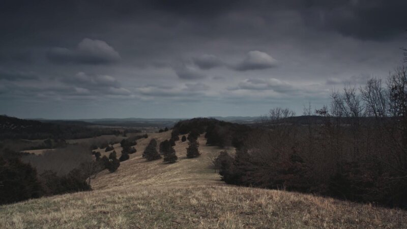 dark sky over rolling hills