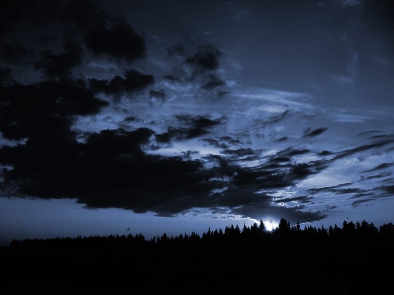 Dark sky with clouds and trees