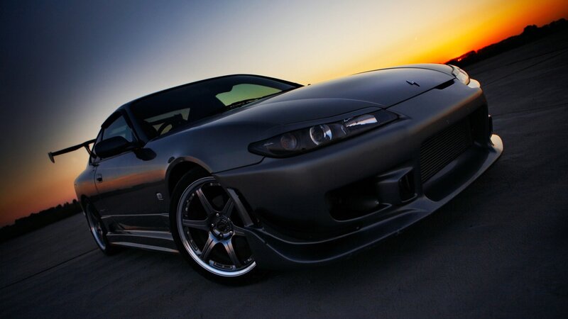 dark sports car at sunset
