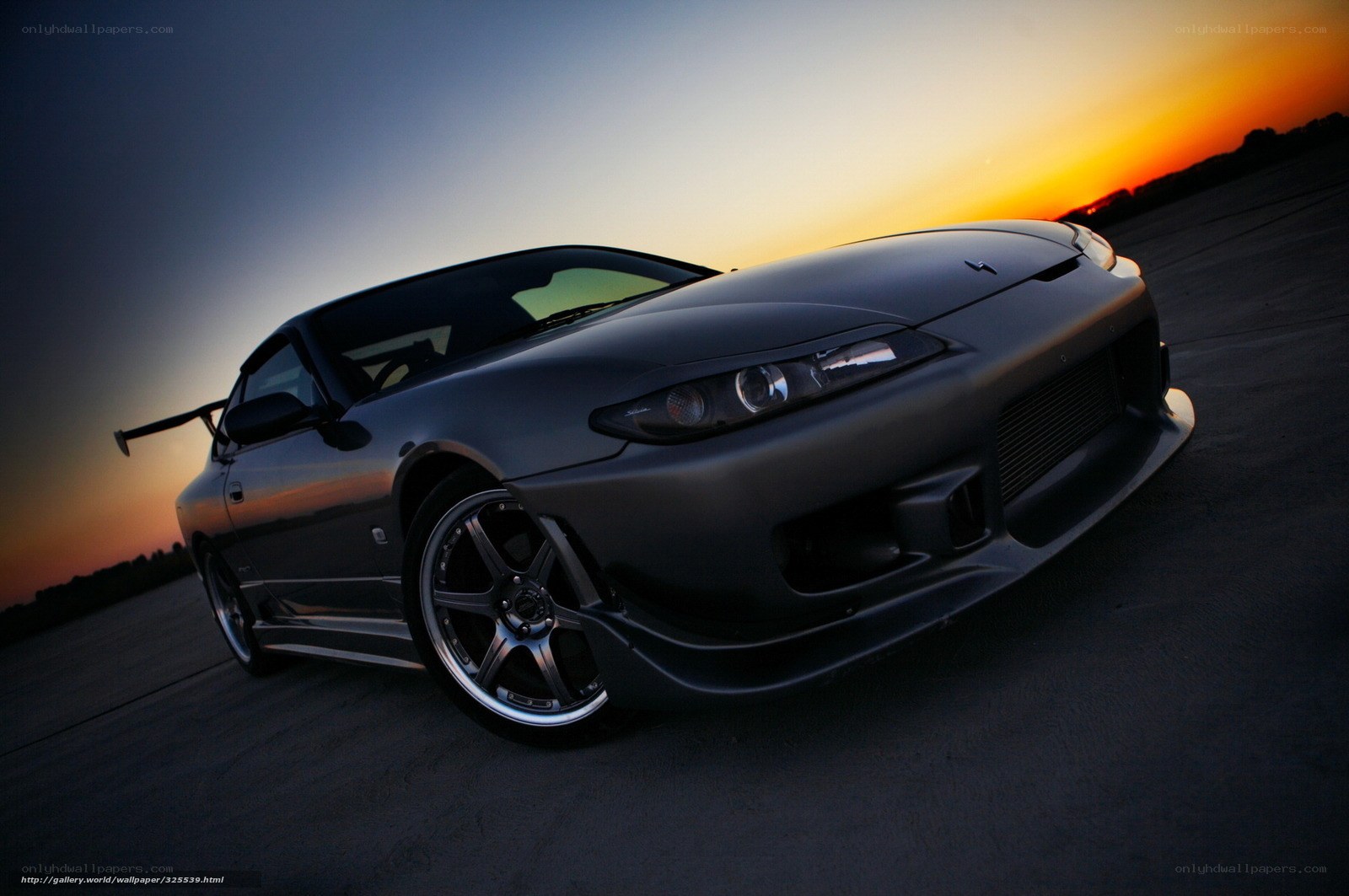 Dark sports car at sunset