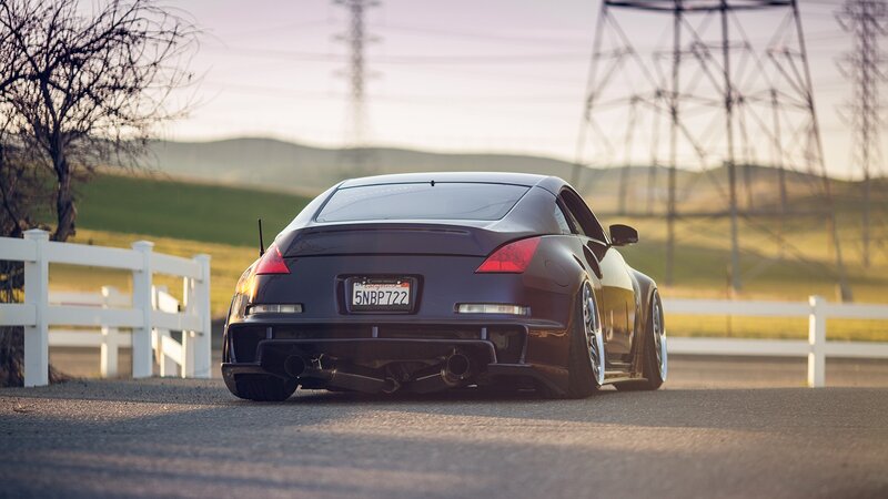 dark sports car on rural road
