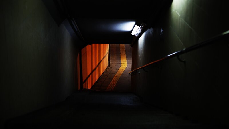 dark stairwell with light at end