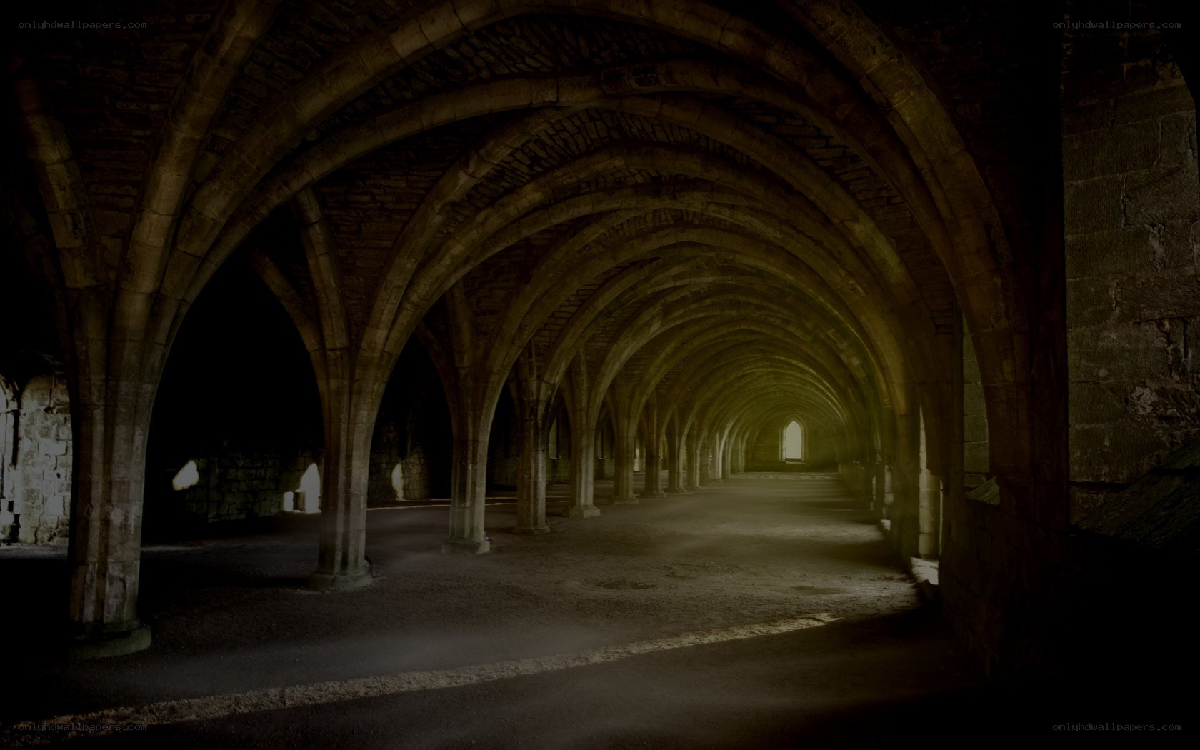 Dark stone corridor with arches