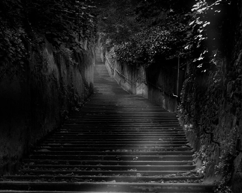 dark stone staircase in a tunnel