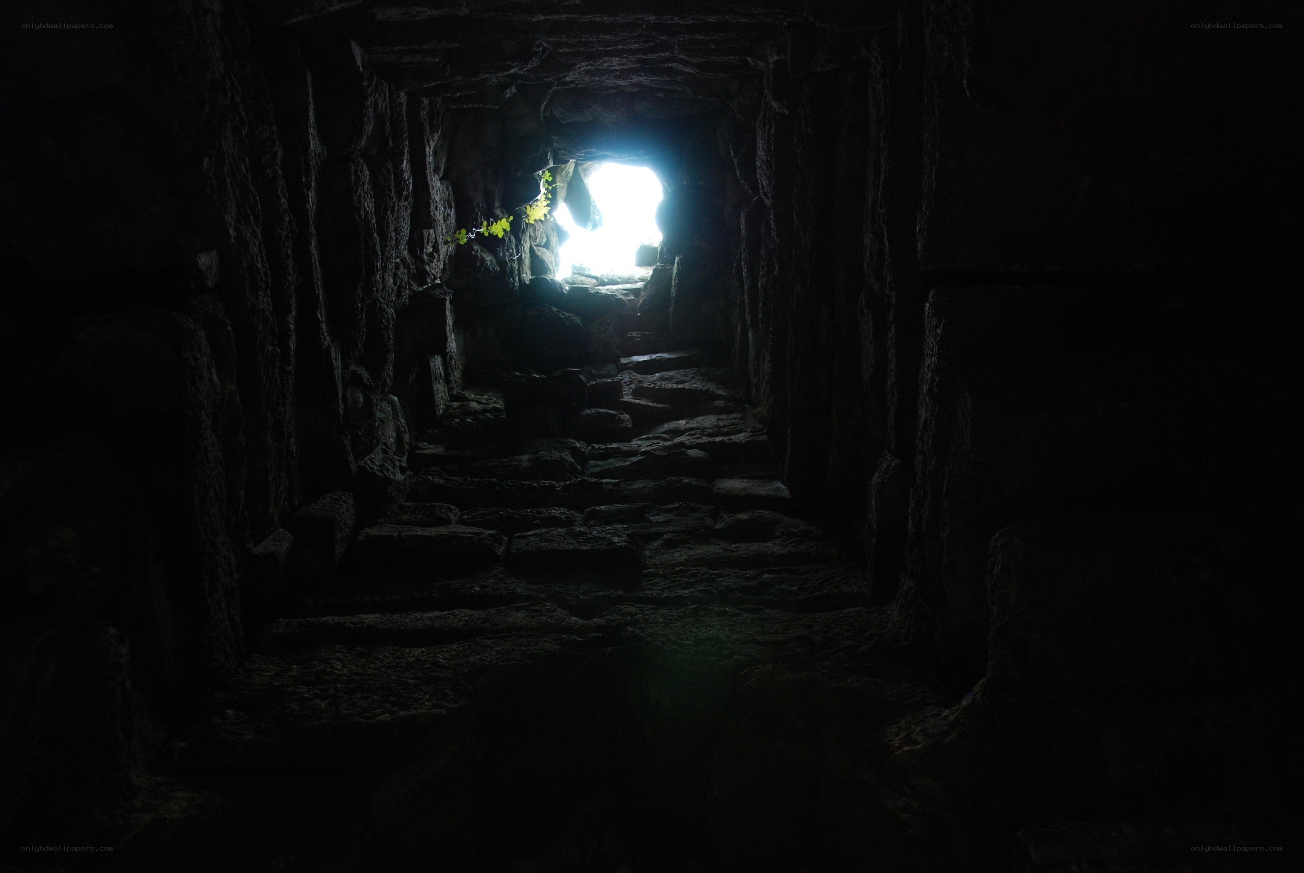 dark stone tunnel with light