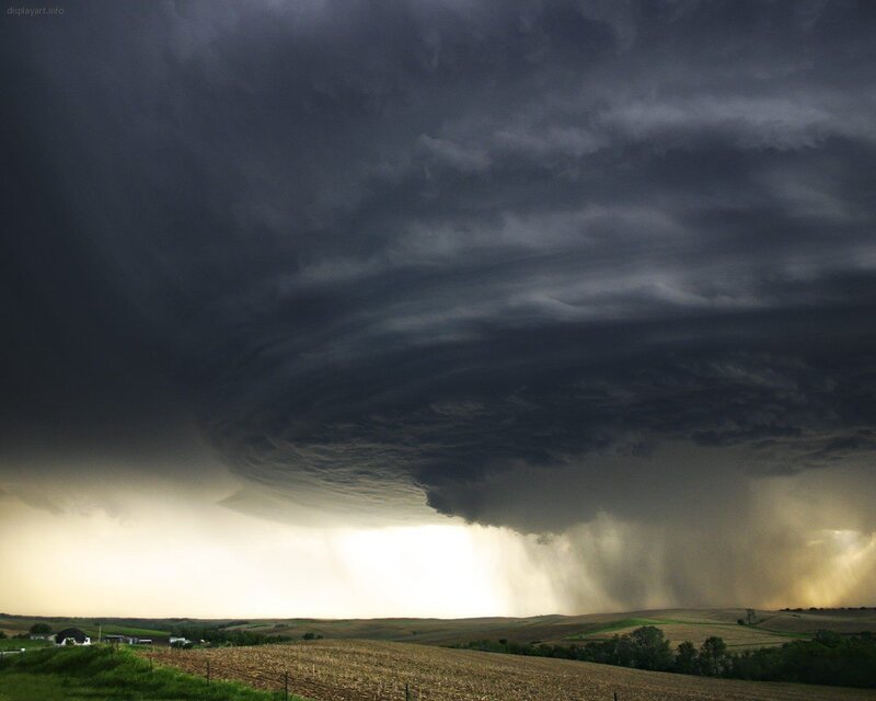 Dark storm cloud over farmland