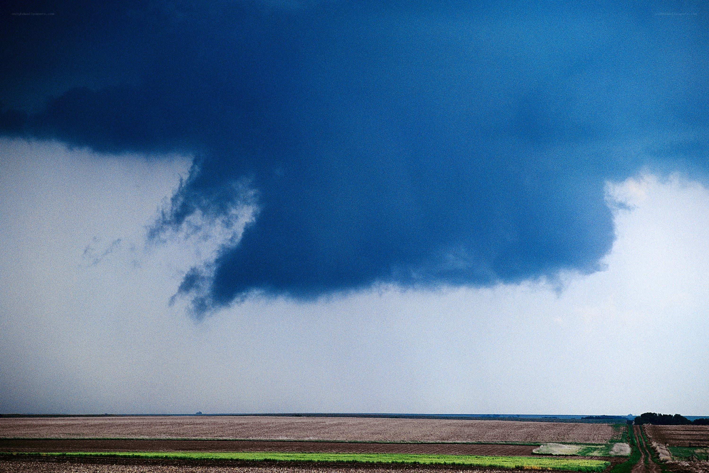 Dark storm cloud over farmland