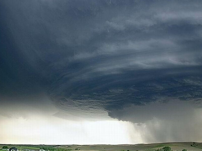 Dark storm cloud over farmland