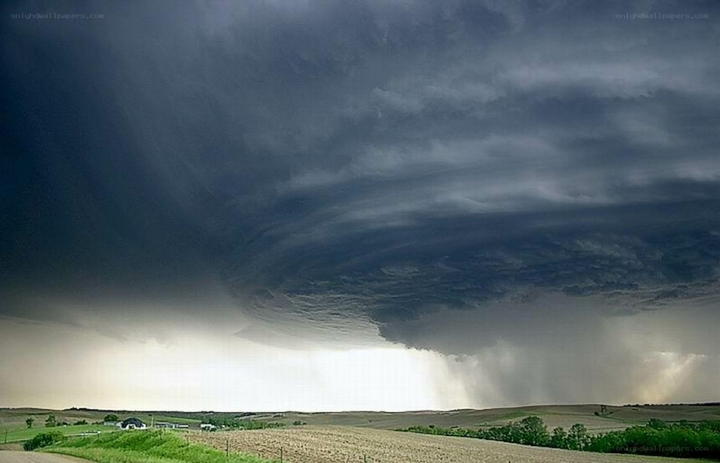 Dark storm cloud over farmland