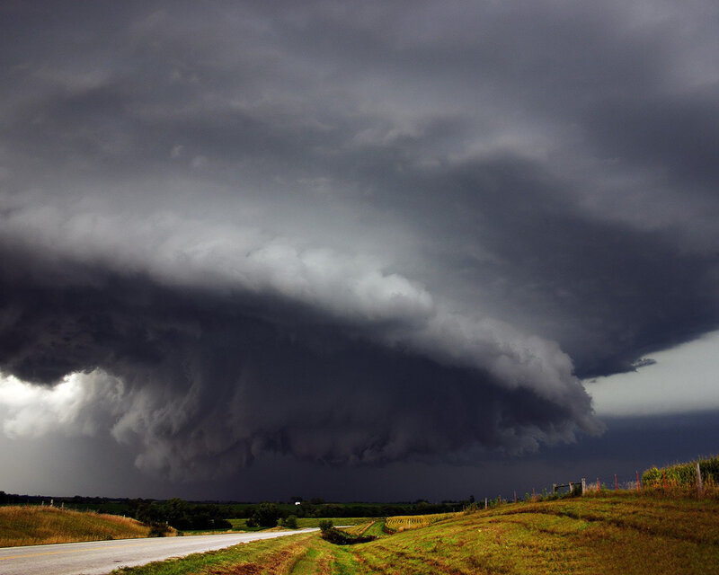 Dark storm cloud over rural road