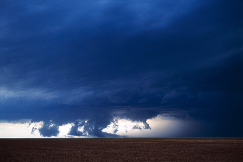 Dark storm clouds over a field