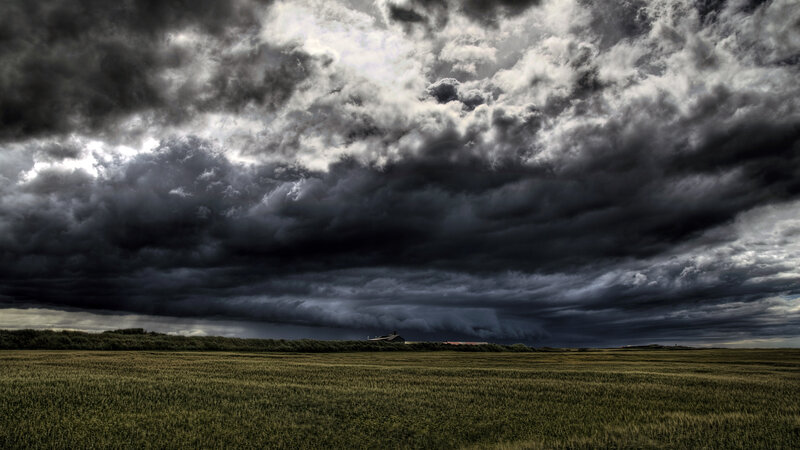Dark storm clouds over a field