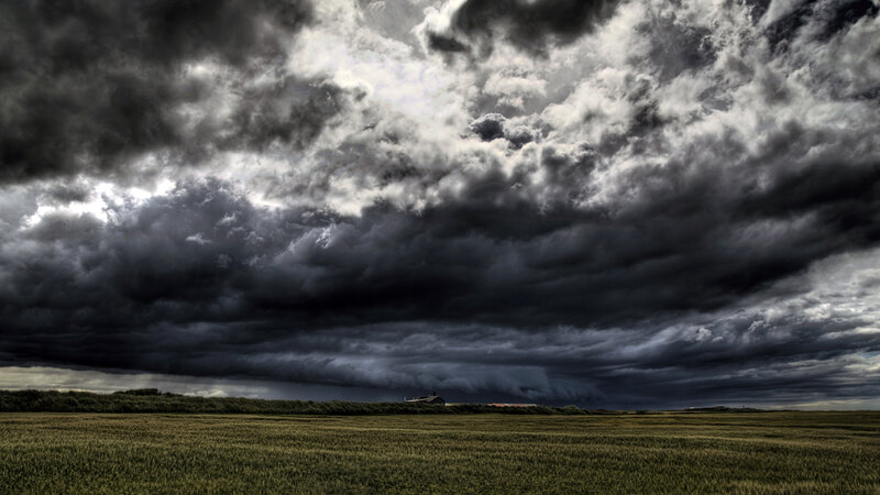 Dark storm clouds over a field