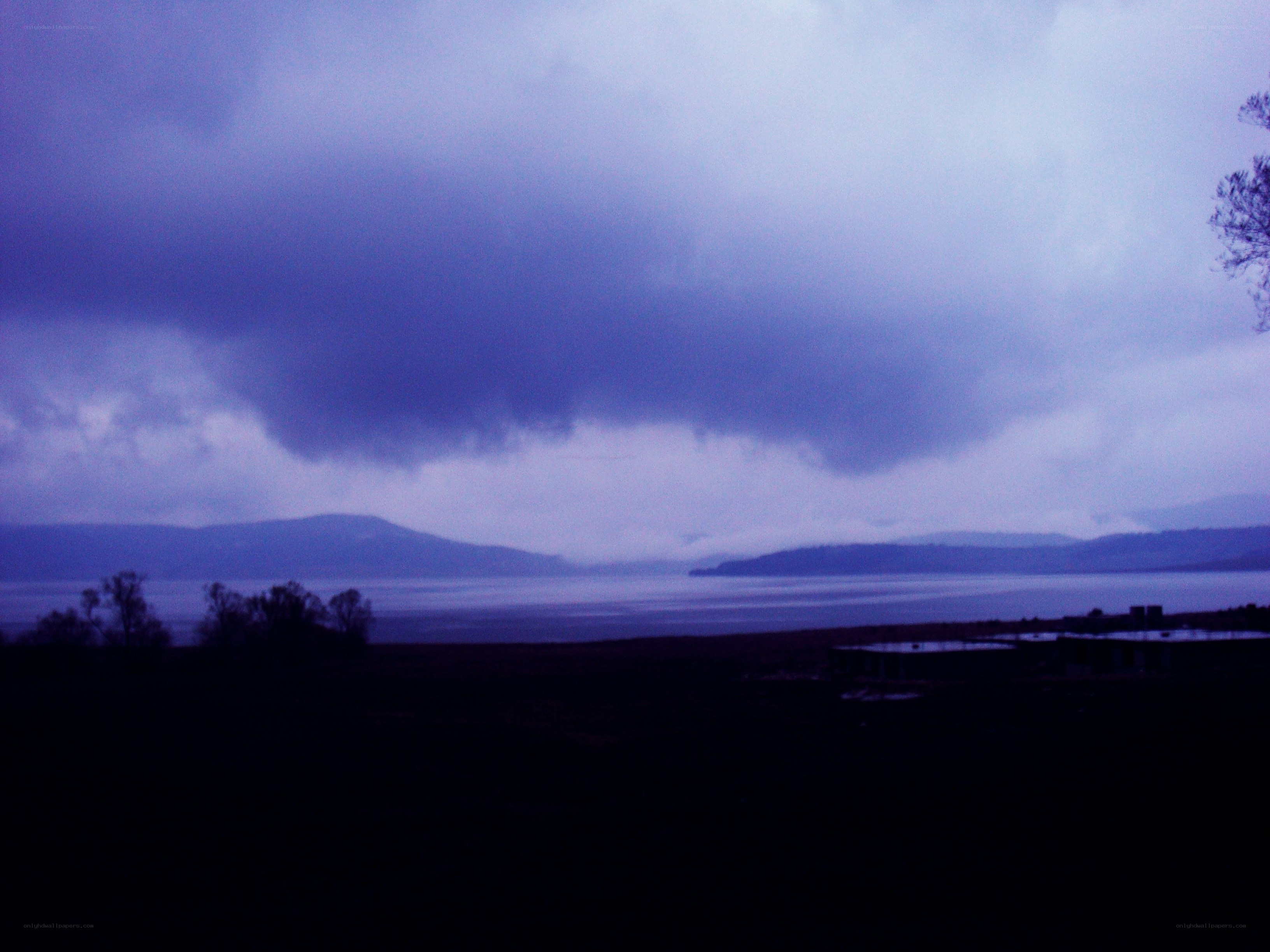 dark storm clouds over a lake