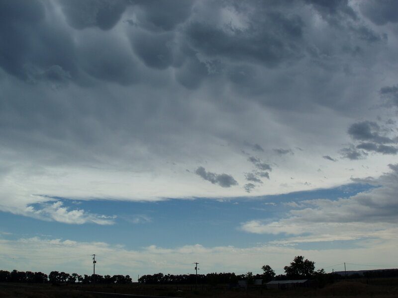 Dark storm clouds over a rural landscape