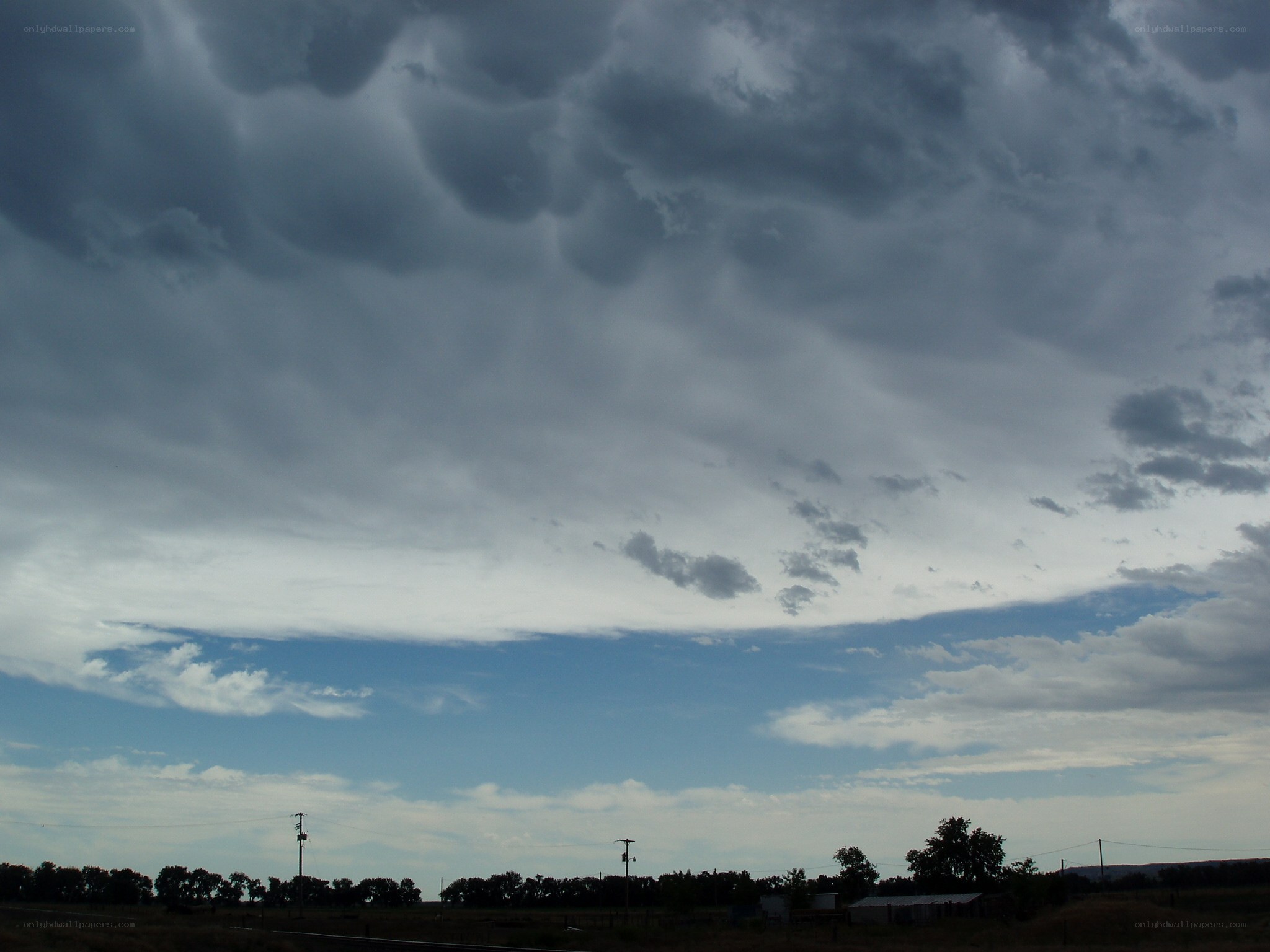 Dark storm clouds over a rural landscape