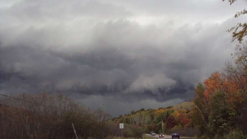 Dark storm clouds over autumn road
