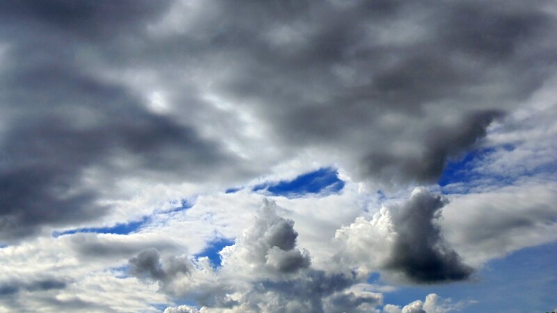 dark storm clouds over blue sky