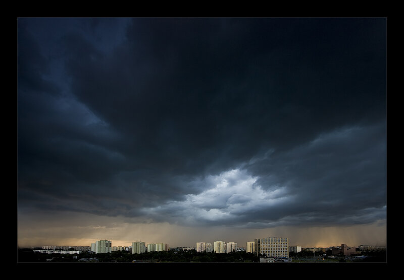 Dark storm clouds over city
