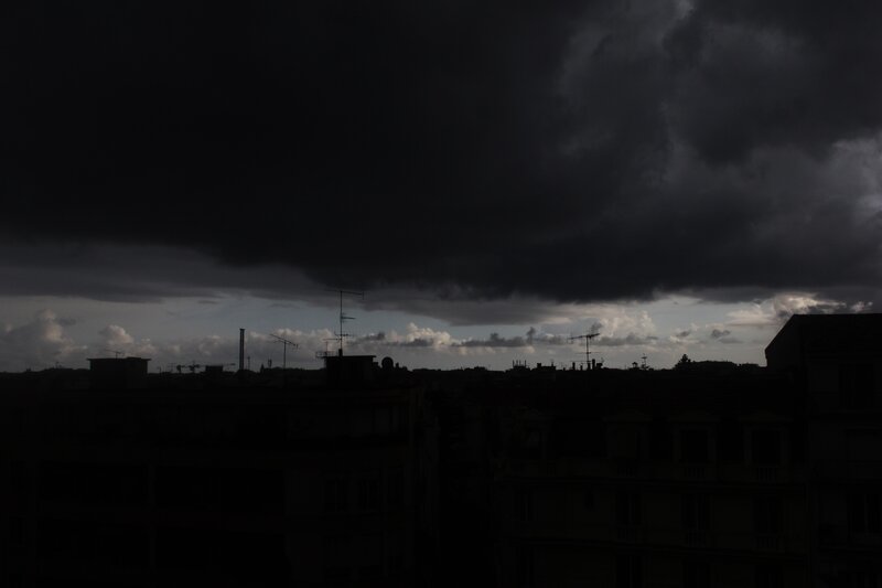 Dark storm clouds over city