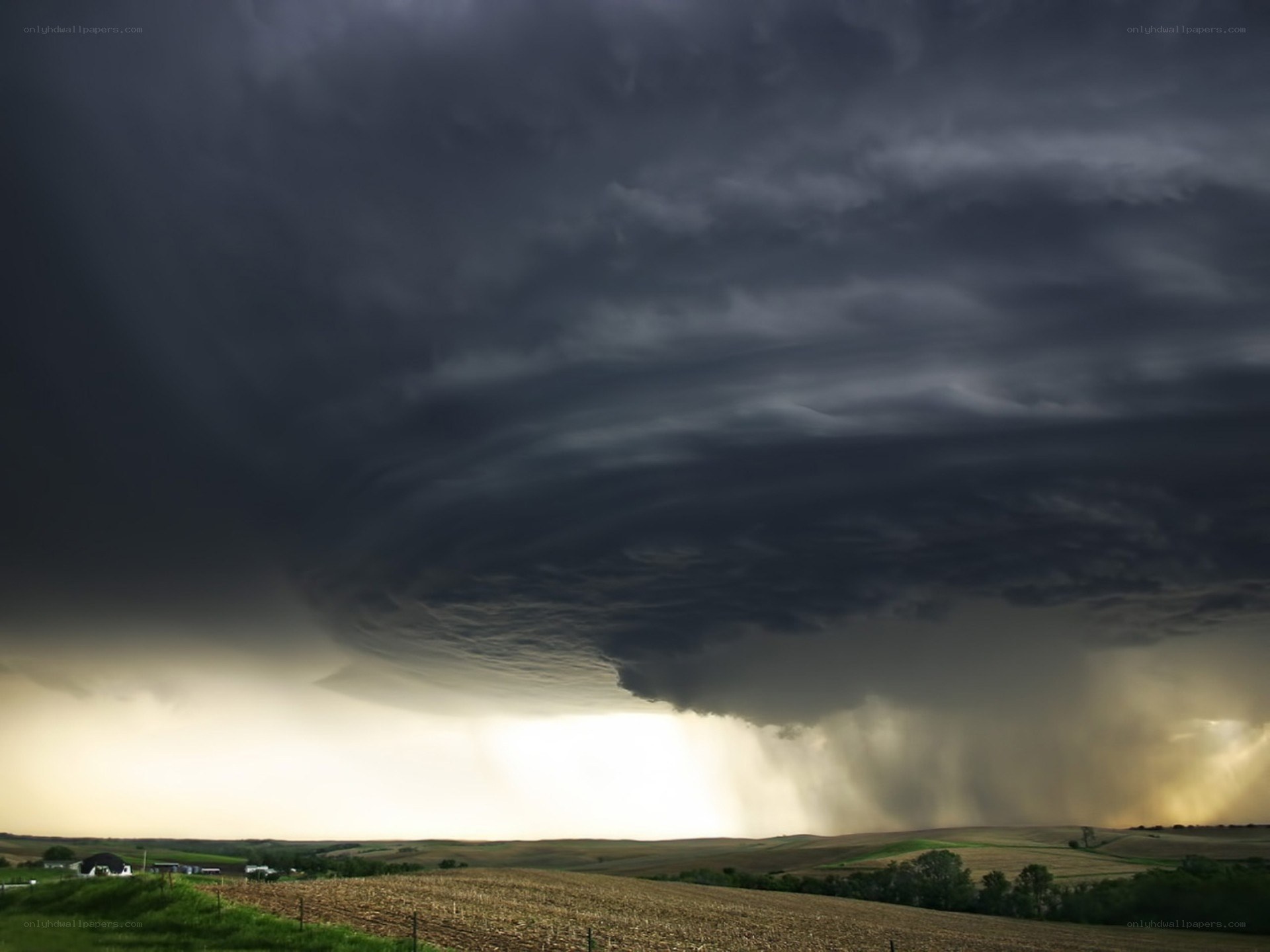 Dark storm clouds over farmland