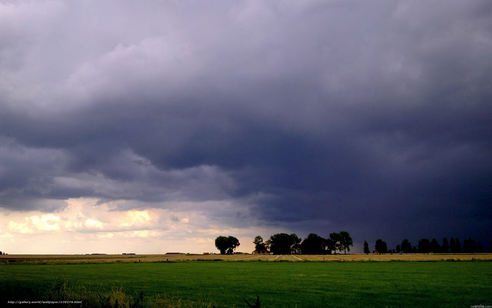 Dark storm clouds over farmland