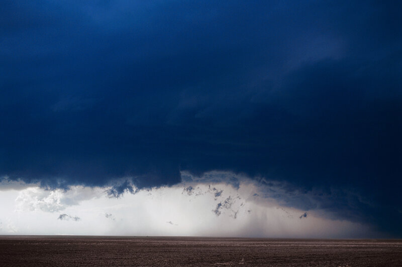 Dark storm clouds over flat land