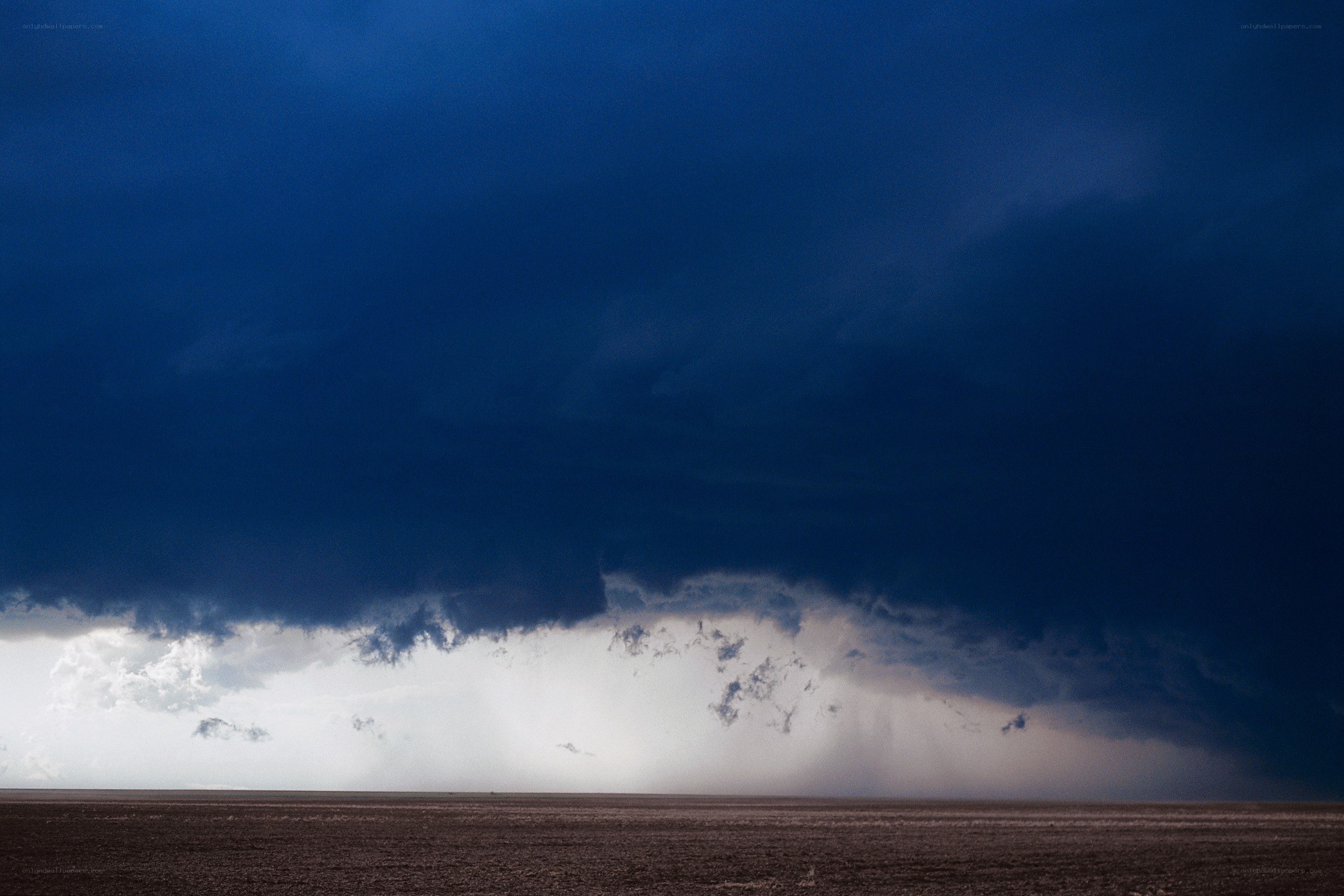 Dark storm clouds over flat land