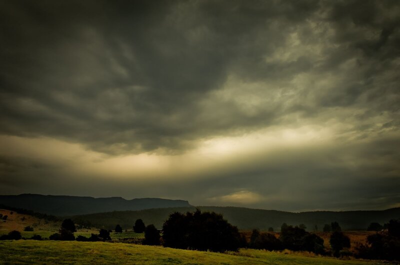 Dark storm clouds over hills