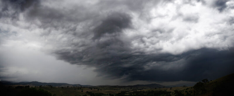 Dark storm clouds over hills