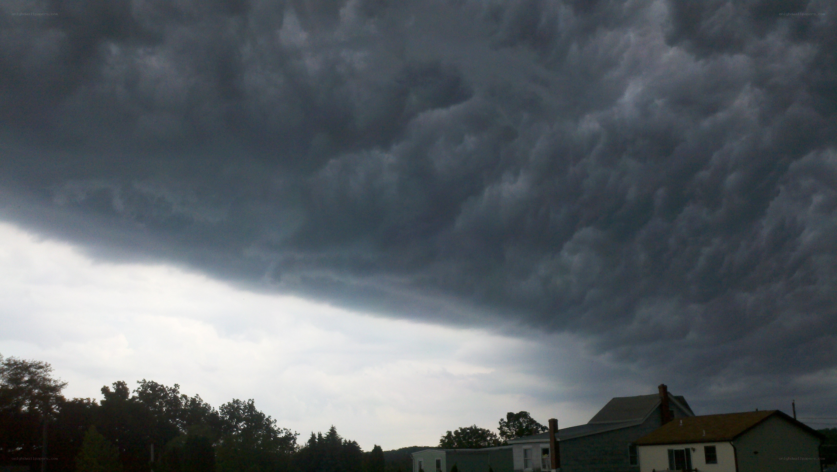 dark storm clouds over houses