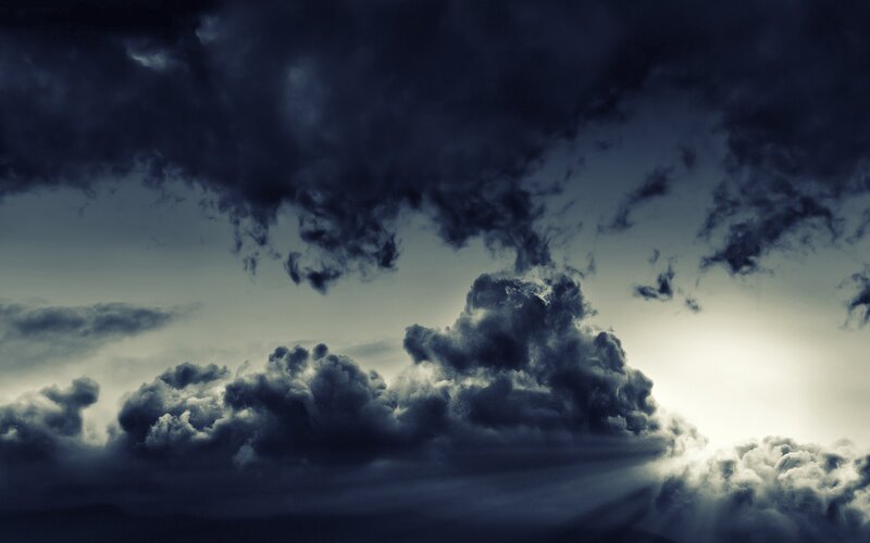 Dark storm clouds with sunlight