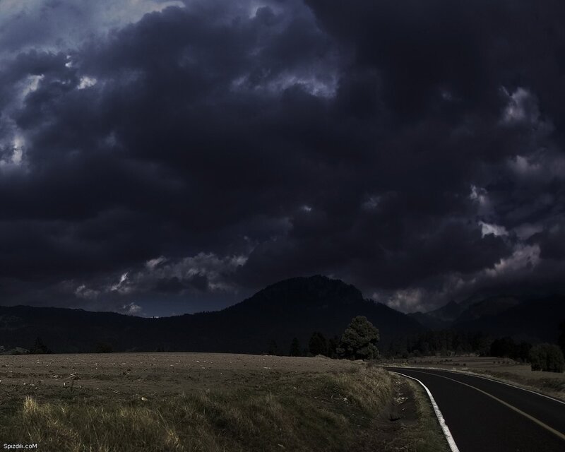 Dark storm over mountain road