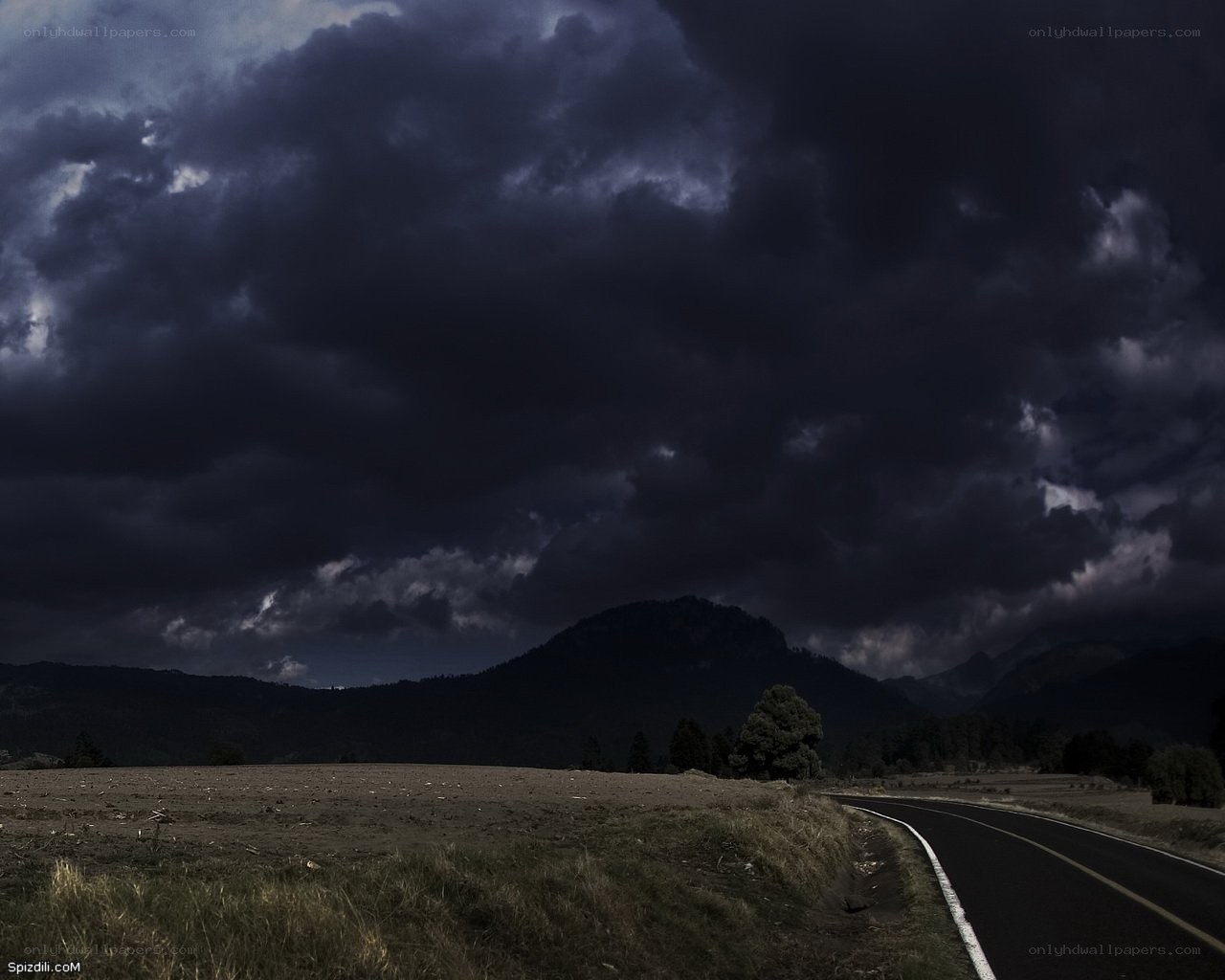 Dark storm over mountain road