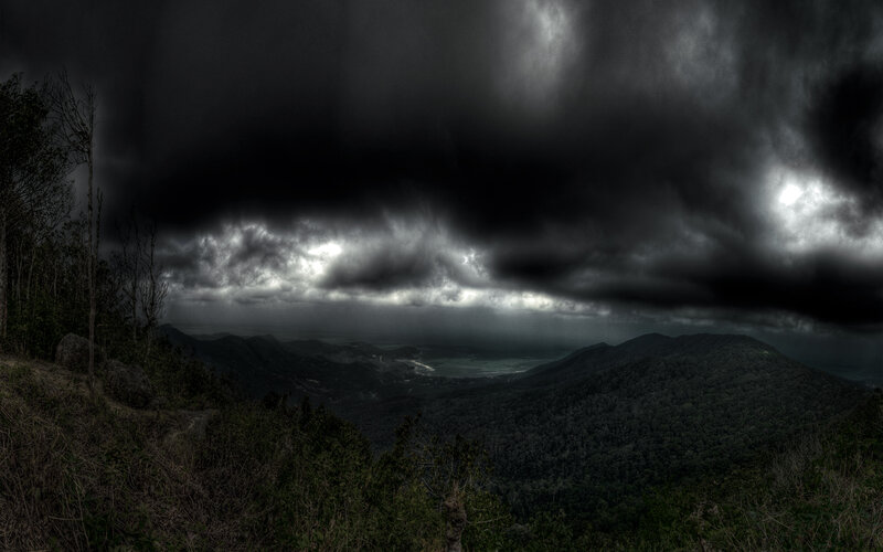 Dark storm over mountain valley