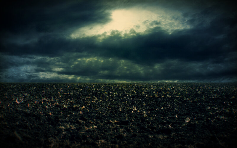 Dark storm over plowed field