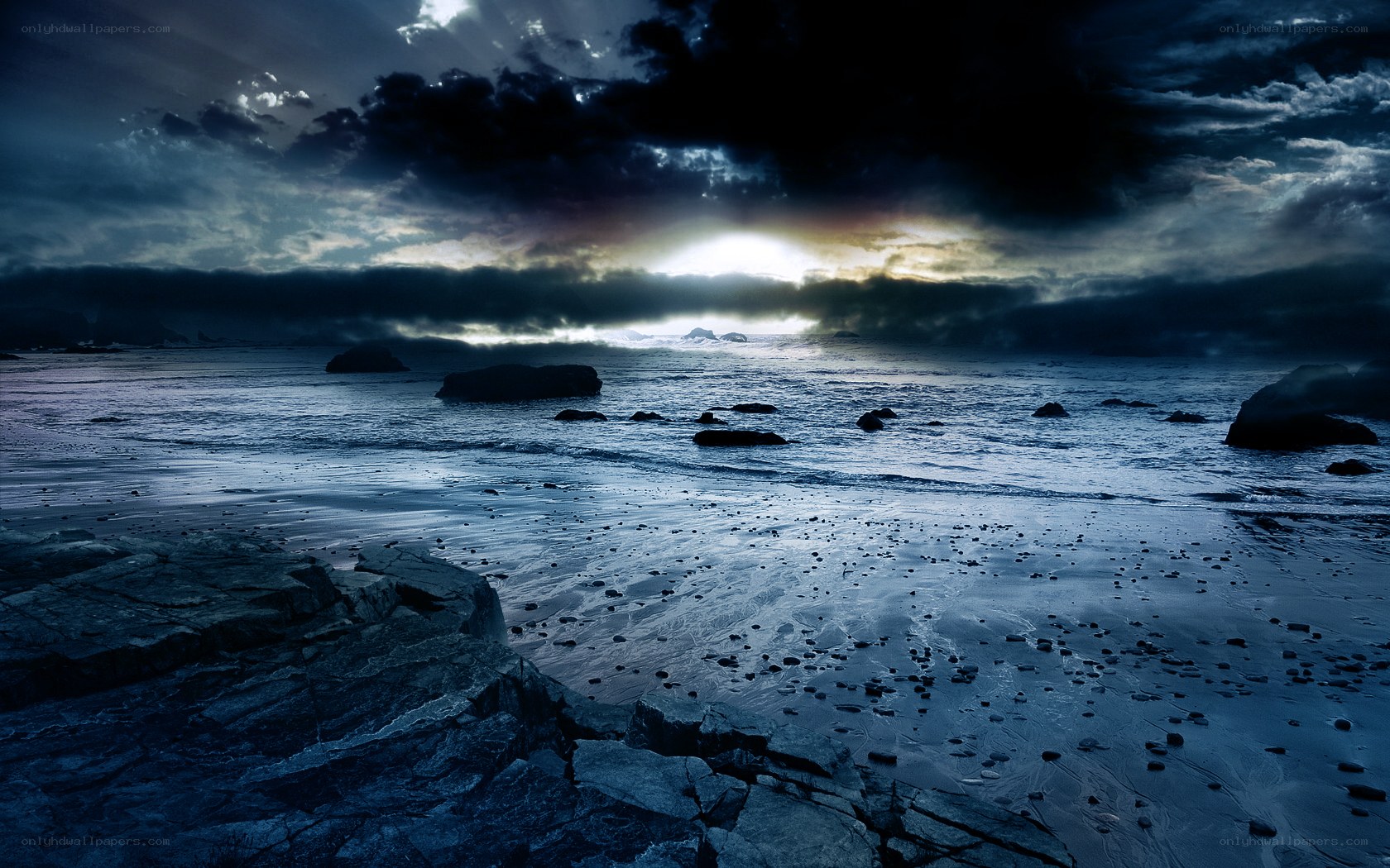 Dark storm over rocky beach