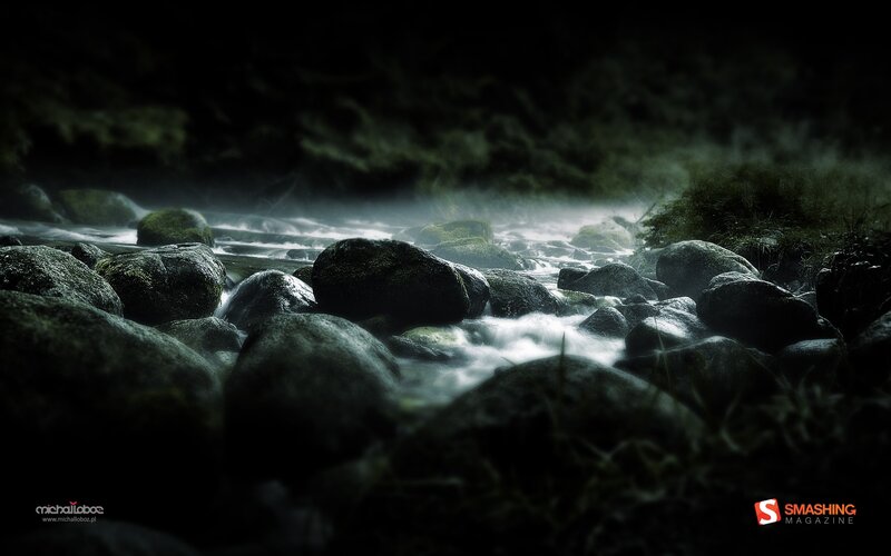 Dark stream flowing over rocks