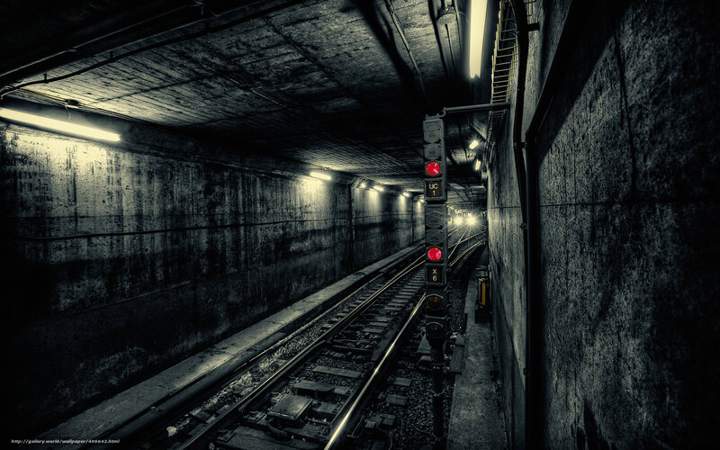 Dark subway tunnel with red signal