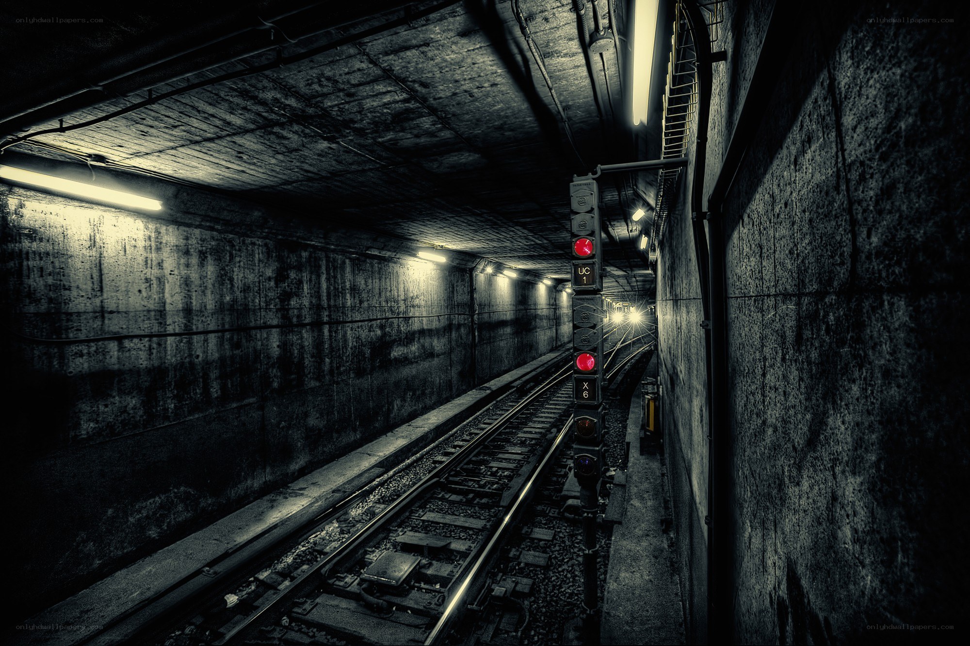 dark subway tunnel with train tracks
