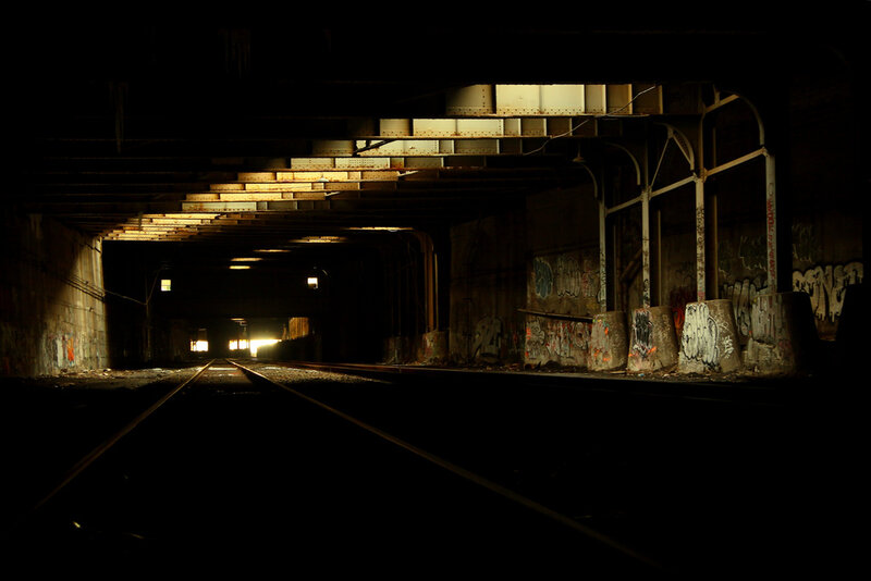 dark train tunnel with graffiti