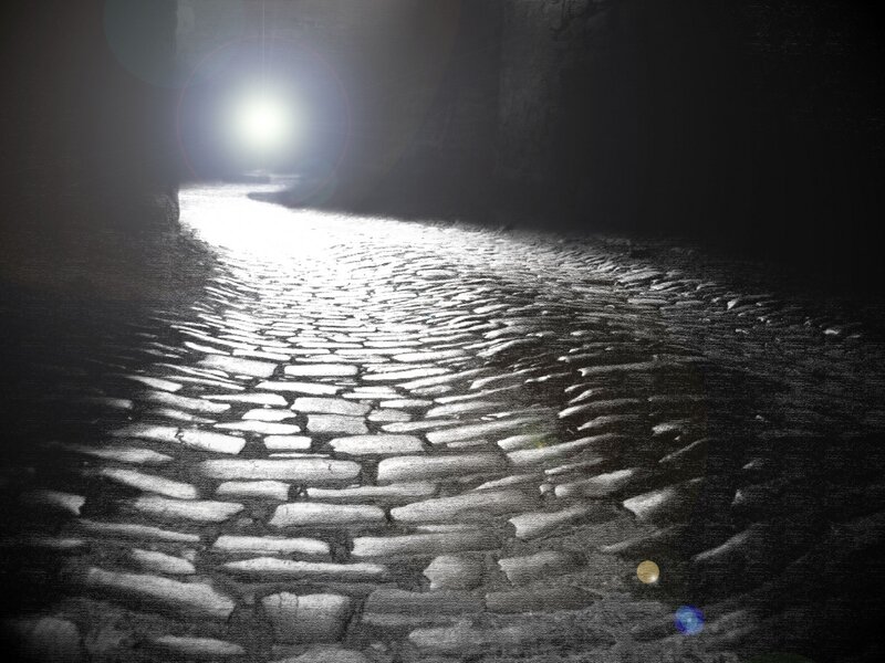 dark tunnel with cobblestone path