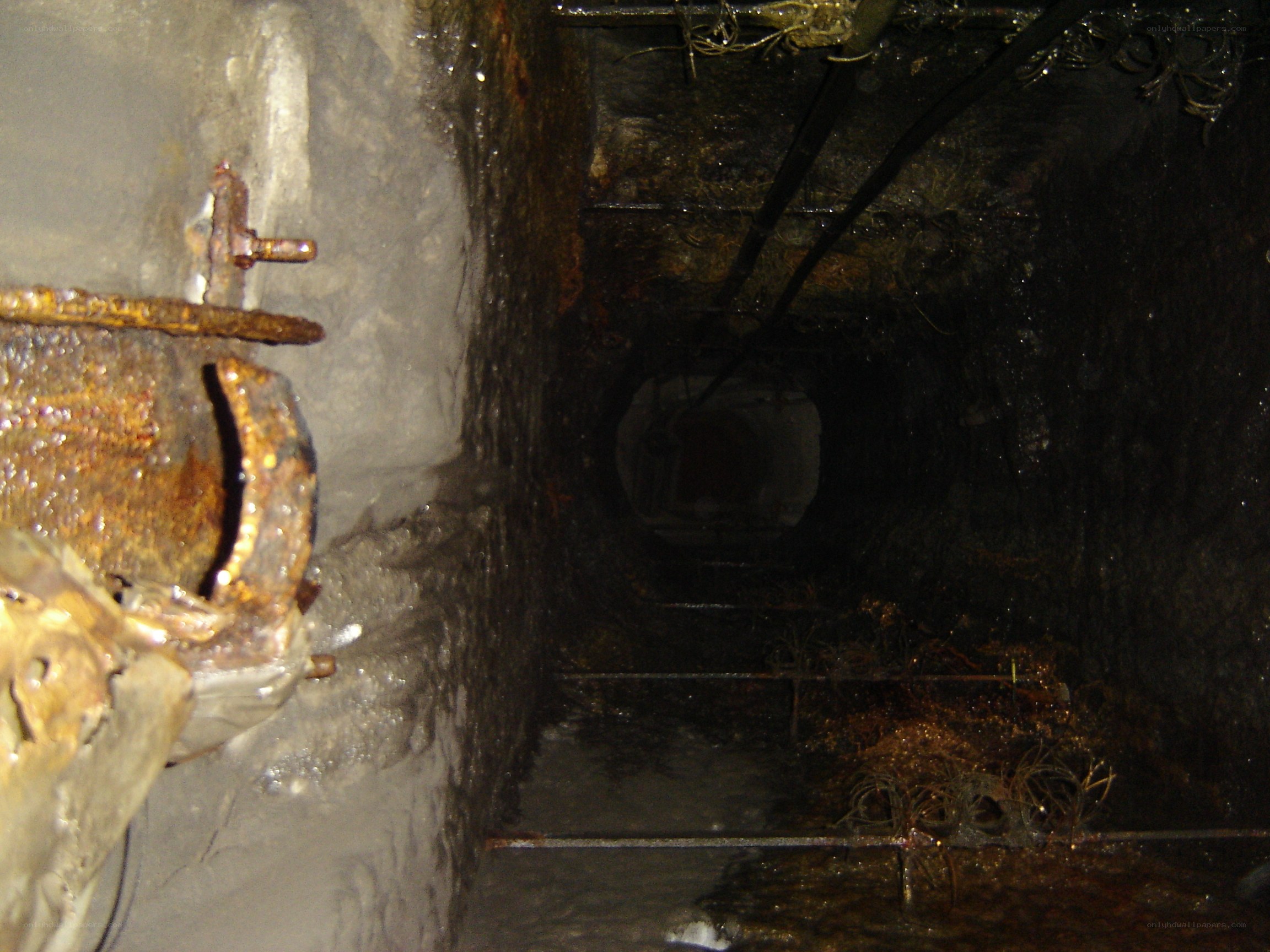 dark tunnel with rusted pipes