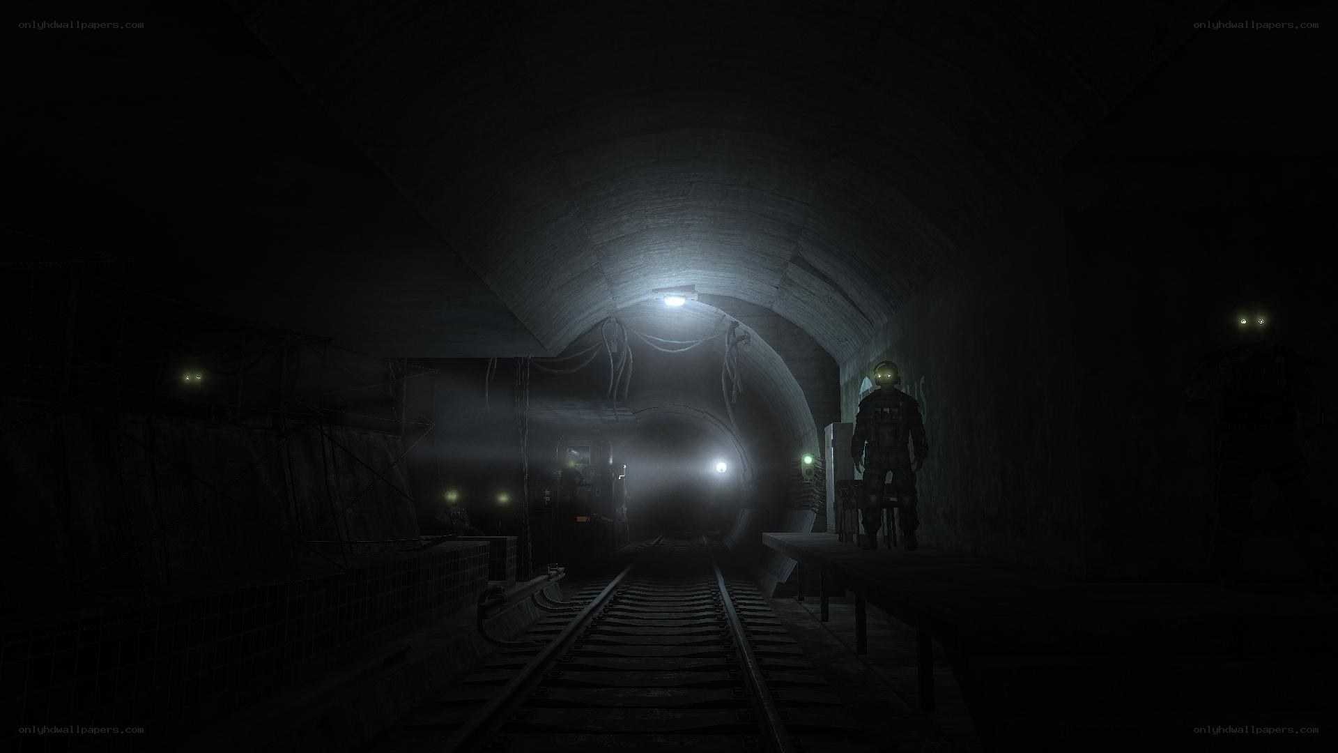 dark tunnel with train tracks