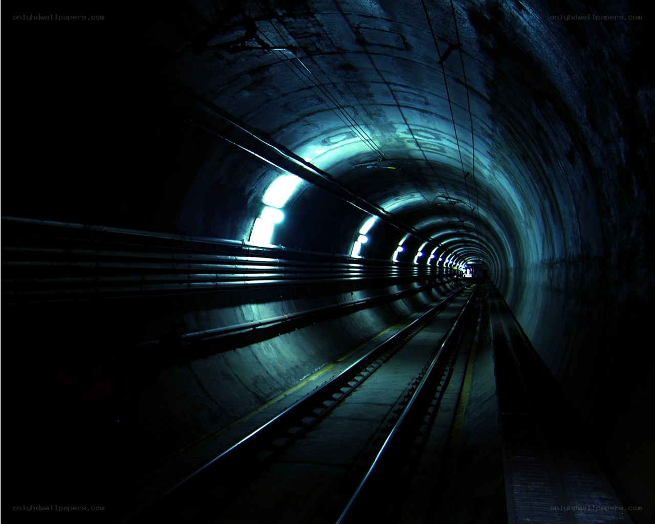 dark tunnel with train tracks
