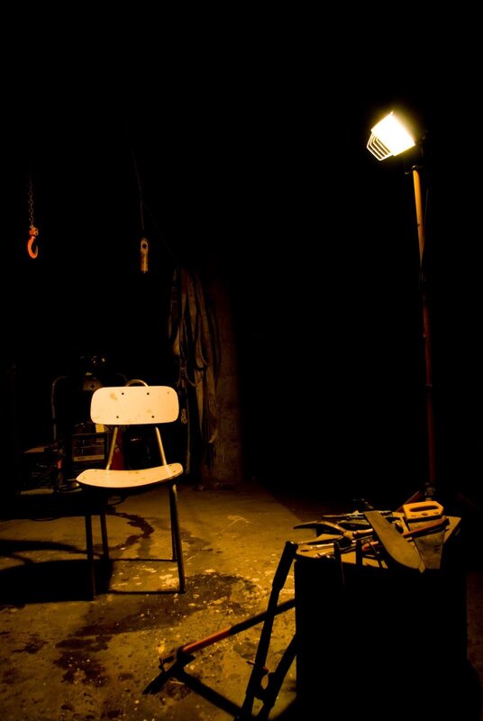 dark workshop with chair and tools