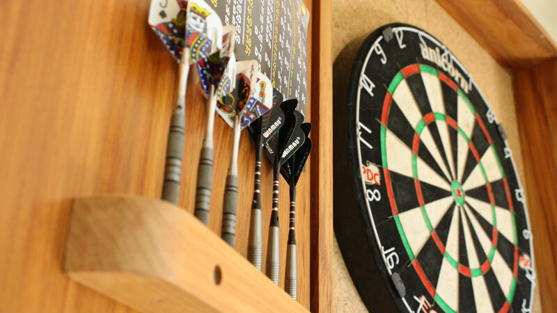 Darts set on wooden wall
