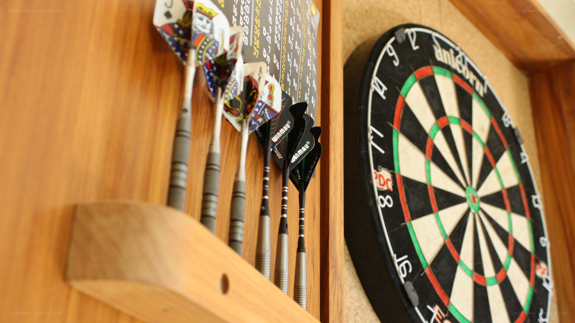 Darts set on wooden wall