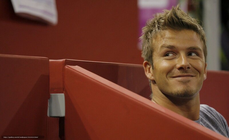 David Beckham smiling in red seating